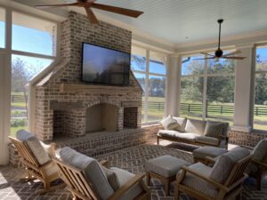 Outdoor TV mounted above a fireplace