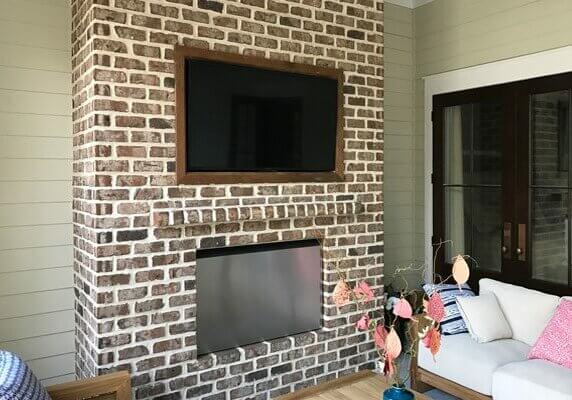 Custom Framed TV Recessed on a Brick Wall